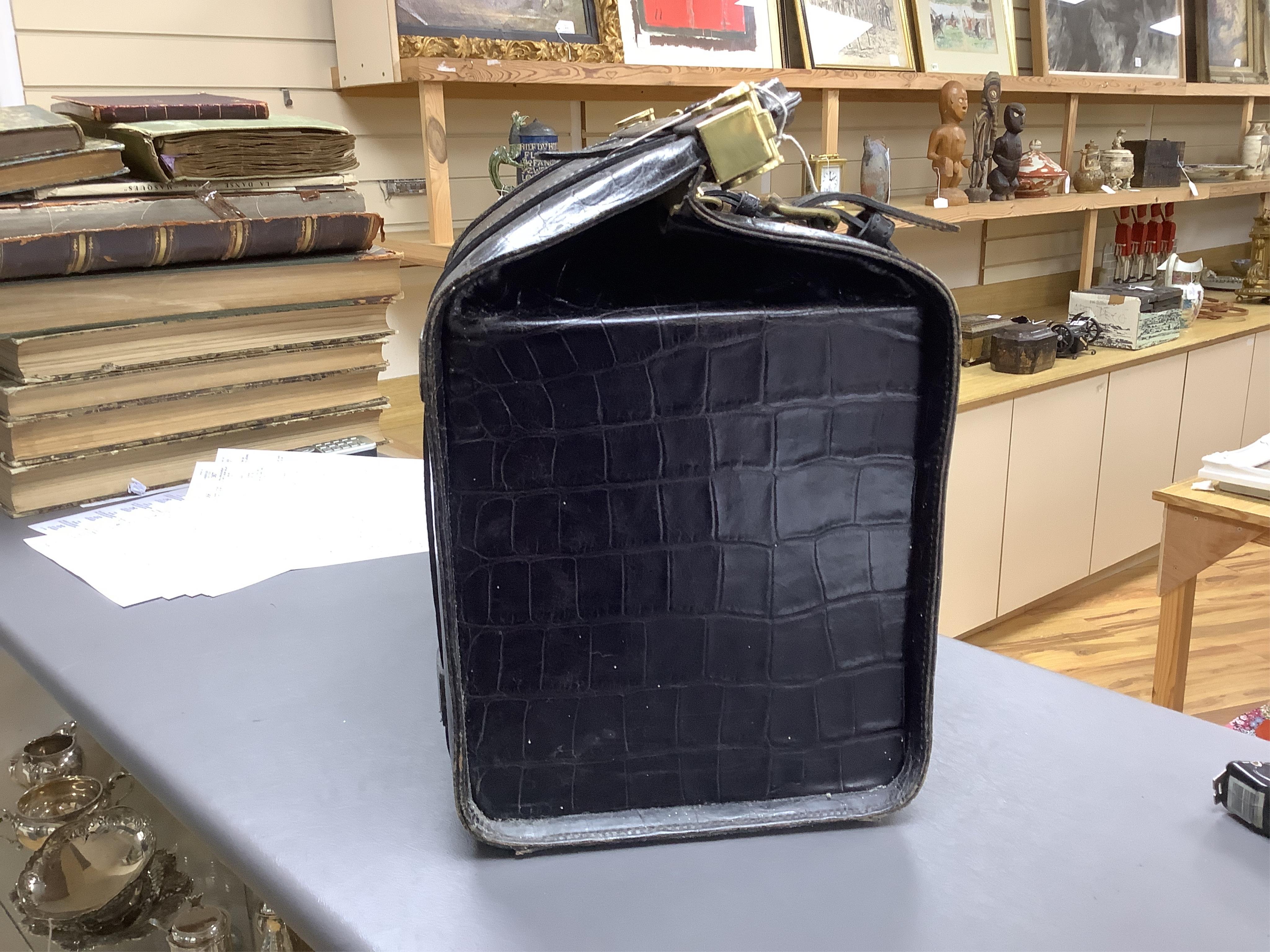 A 1940’s ladies crocodile skin Gladstone bag with gilt metal hardware, 34cm wide
